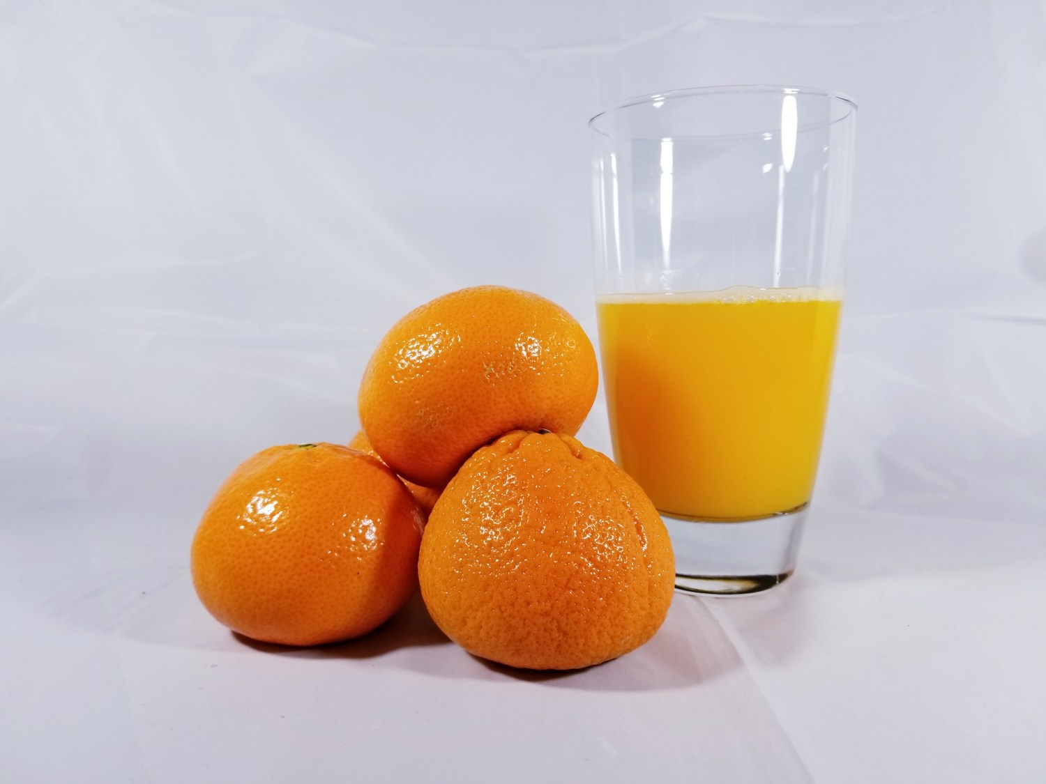 Mandarin oranges and a glass of orange juice